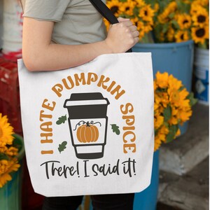 May include: White tote bag with the text "I hate pumpkin spice. There! I said it!" in black lettering. A coffee cup with a pumpkin inside is illustrated in the centre of the bag.