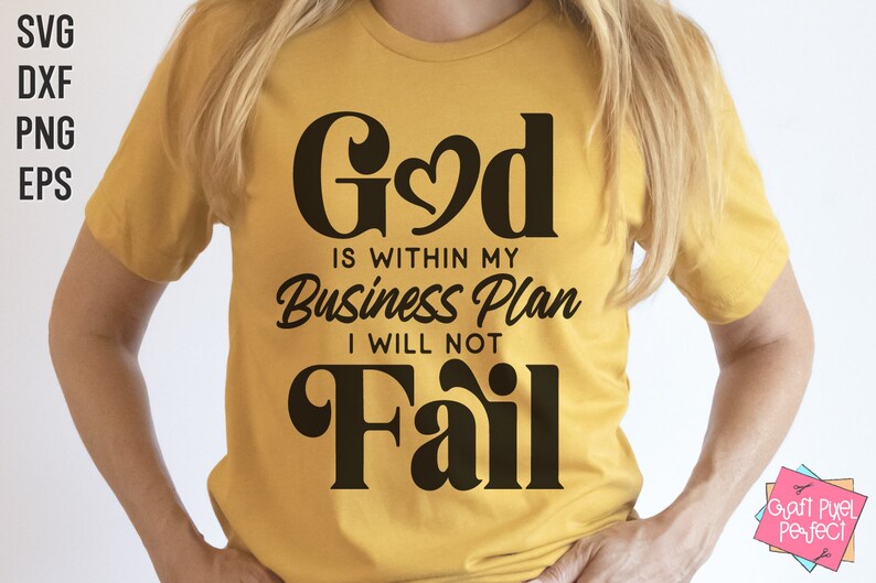May include: A yellow t-shirt with the text "God is within my Business Plan I will not Fail" in black lettering. The word "God" has a heart in the middle of the "o".