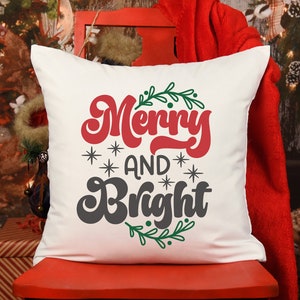 May include: White pillow with the text "Merry and Bright" in red and black lettering with green holly leaves around the text.