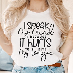 May include: A white t-shirt with black text that reads "I speak my mind because it hurts to bite my tongue".
