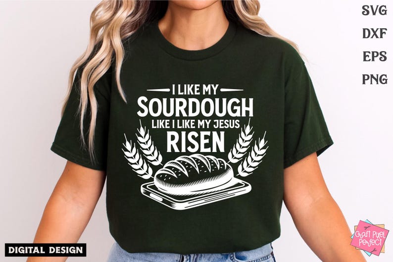 May include: A green t-shirt with a white graphic design that says "I like my sourdough like I like my Jesus risen". The graphic also includes a loaf of bread on a plate and wheat stalks.