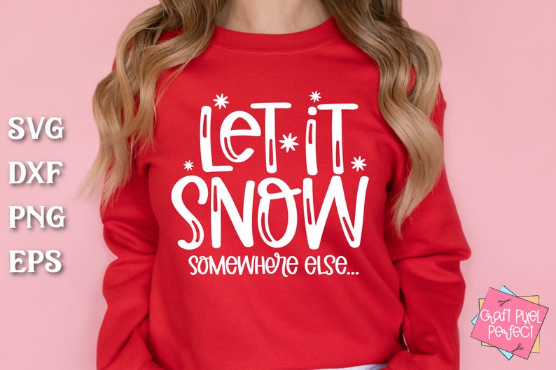 May include: Red sweatshirt with white text that says "Let it snow somewhere else..."