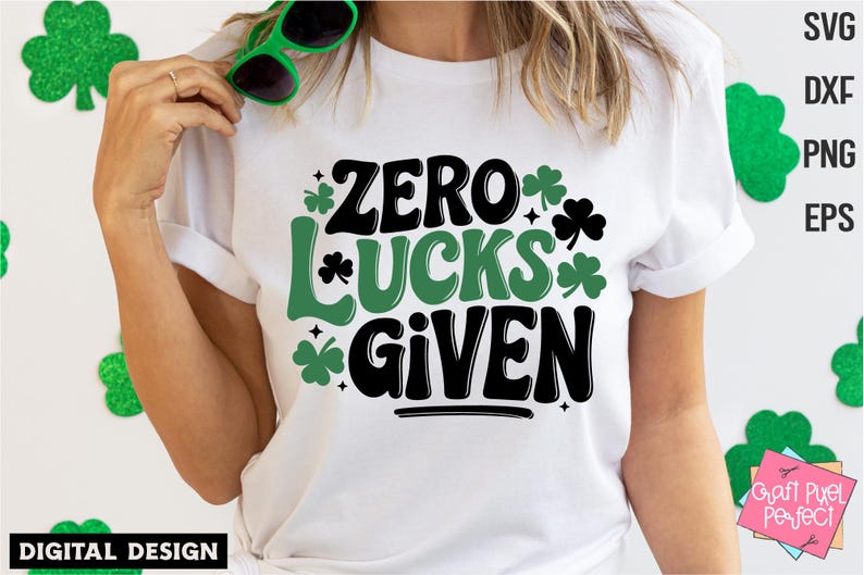 May include: White t-shirt with a black and green graphic that says "Zero Lucks Given". The graphic includes shamrock designs.