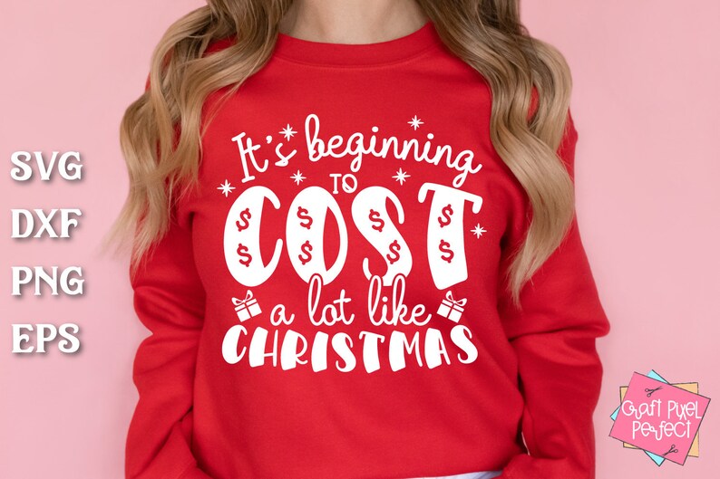 May include: Red sweatshirt with white text that reads "It's beginning to cost a lot like Christmas". The text is surrounded by stars and dollar signs.