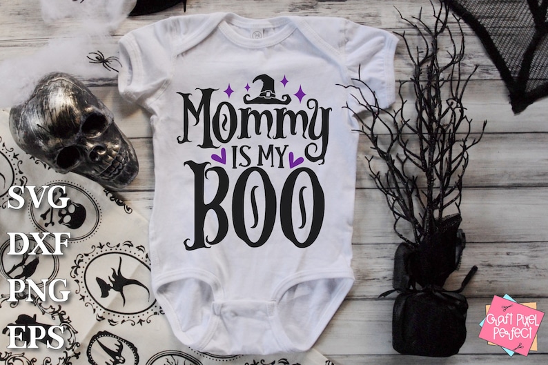 May include: White baby onesie with black text that reads "Mommy is my Boo" with a witch hat and purple hearts.