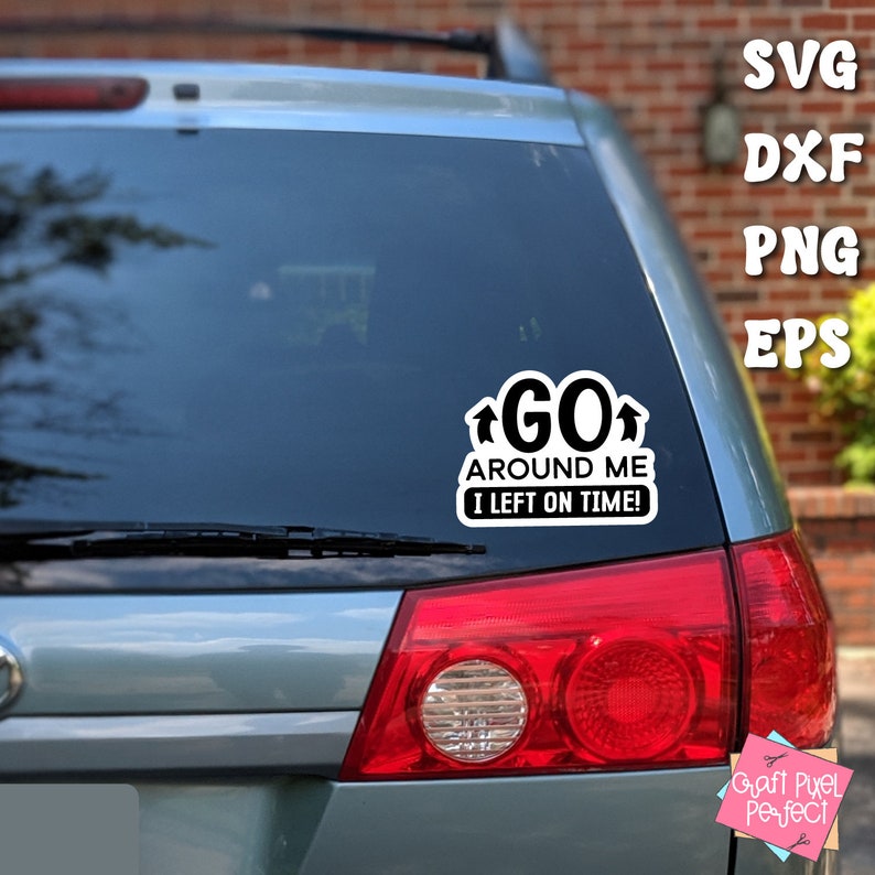 May include: A black and white car sticker with the text "GO AROUND ME I LEFT ON TIME!" on a blue car. The sticker is on the back window of the car.
