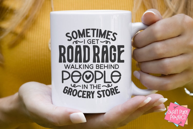 K&ouml;nnte beinhalten: Wei&szlig;e Keramiktasse mit schwarzem Text, der "Sometimes I get road rage walking behind people in the grocery store" lautet.