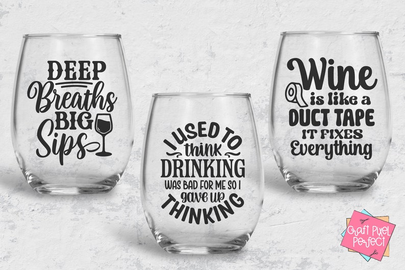 May include: Three clear glass wine glasses with black vinyl lettering. The first glass says "Deep Breaths Big Sips" with a small wine glass icon. The second glass says "I used to think drinking was bad for me so I gave up thinking". The third glass says "Wine is like a duct tape it fixes everything".