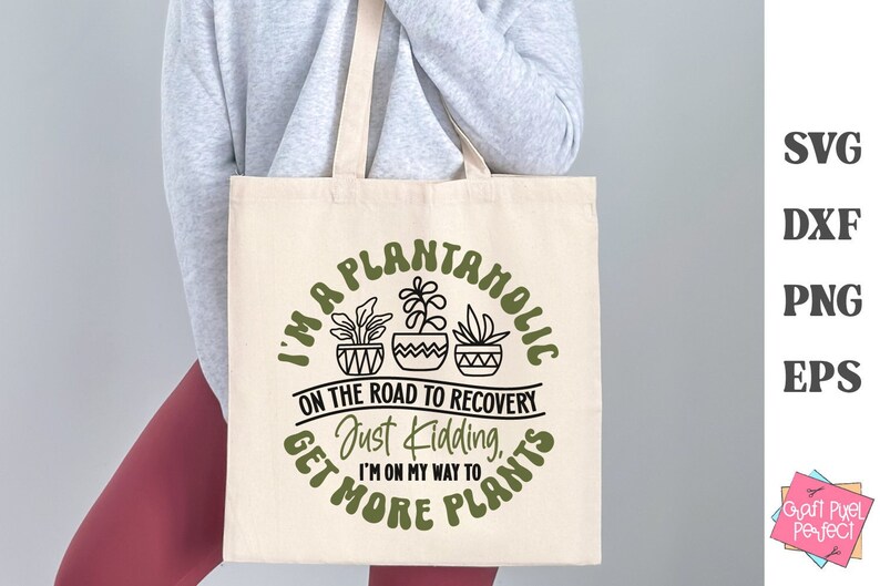 May include: A white tote bag with a green and black design that says "I'm a plantanolic on the road to recovery, just kidding, I'm on my way to get more plants".
