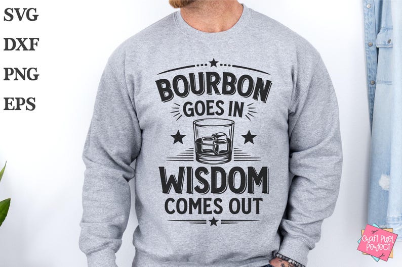 May include: A gray sweatshirt with the text "Bourbon goes in Wisdom comes out" printed on the front. The text is surrounded by stars and a graphic of a glass of bourbon.