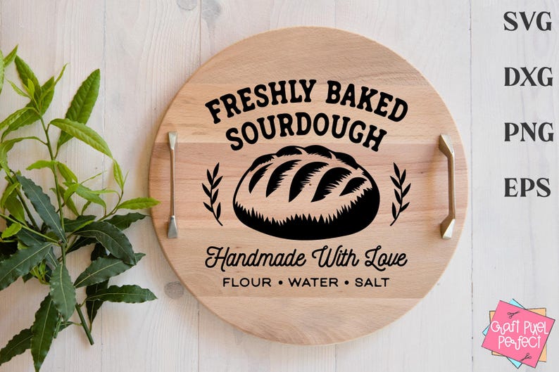 May include: A circular wooden serving board with handles, displaying the text "FRESHLY BAKED SOURDOUGH" and a bread illustration. The text "Handmade With Love" and ingredients are also included. The board is light brown.