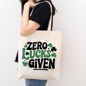 May include: A white tote bag with the text "Zero Lucks Given" in black and green shamrocks.