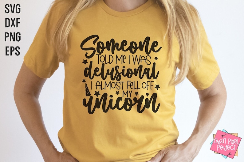 May include: A yellow t-shirt with the text "Someone told me I was delusional I almost fell off my unicorn" in black lettering.