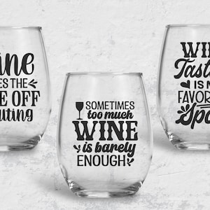 May include: Three stemless wine glasses with humorous sayings about wine. The first glass says "wine takes the edge off adulting". The second glass says "sometimes too much wine is barely enough". The third glass says "wine tasting is my favorite sport".