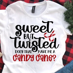 May include: White t-shirt with black text that reads "sweet but twisted does that make me a candy cane?" with a red and white candy cane graphic.