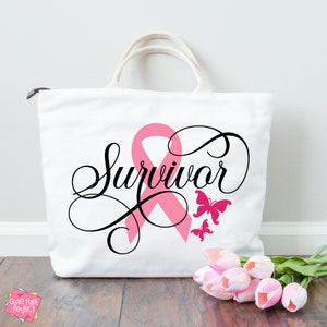 May include: White canvas tote bag with a pink ribbon and the word "Survivor" in black cursive script. Two pink butterflies are on the bag.