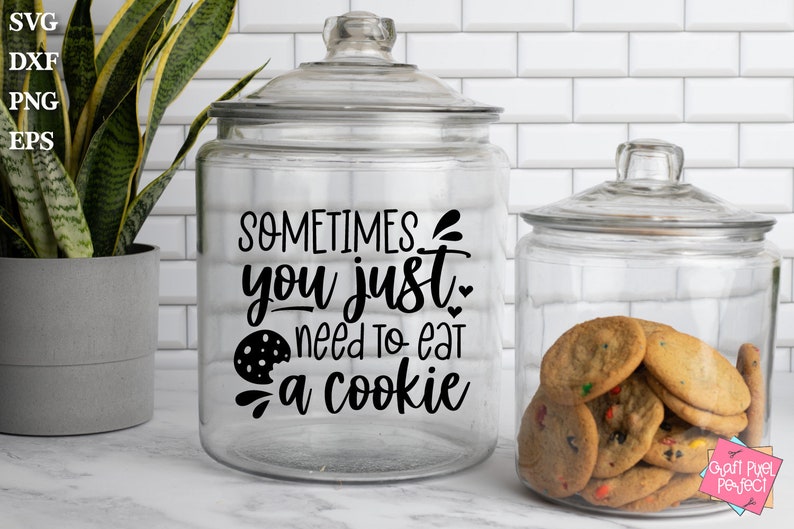 May include: A glass cookie jar with a black vinyl decal that reads "Sometimes you just need to eat a cookie". The jar is filled with chocolate chip cookies.