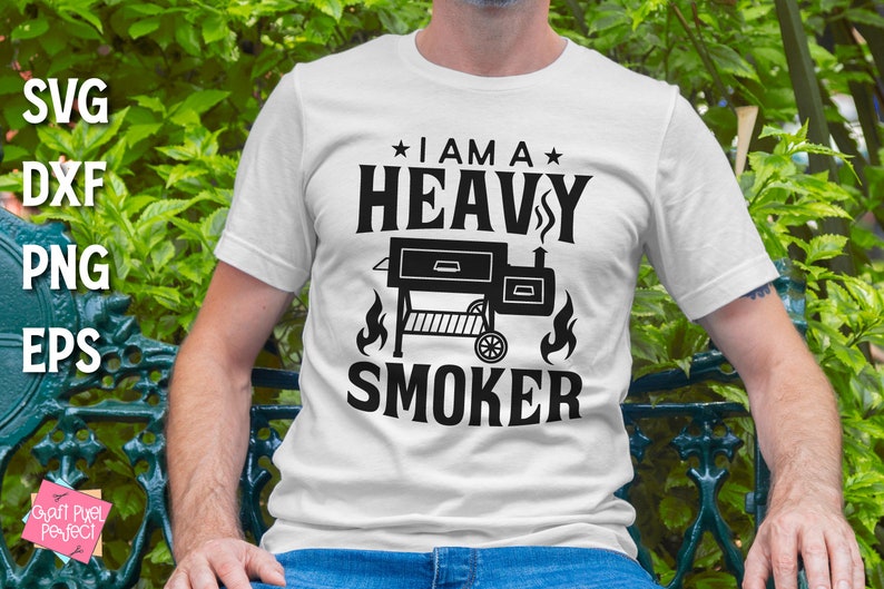 May include: White t-shirt with black text that reads "I am a Heavy Smoker" and a black silhouette of a smoker grill.