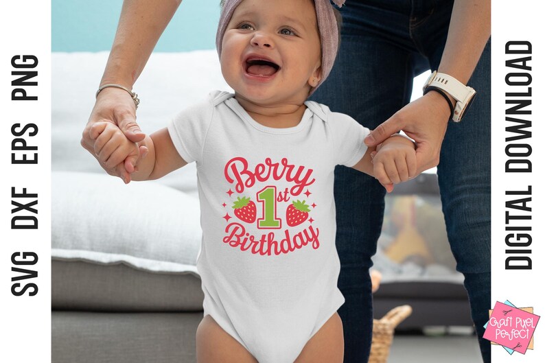 May include: A white onesie with a red and green graphic that says "Berry 1st Birthday". The onesie is being worn by a baby girl.