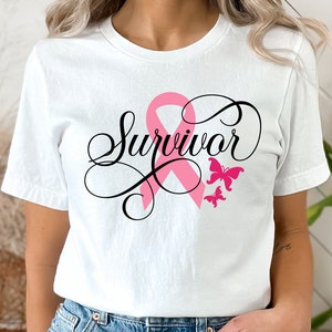 May include: A white t-shirt with a pink ribbon and the word "Survivor" in black script. Two pink butterflies are above the ribbon.