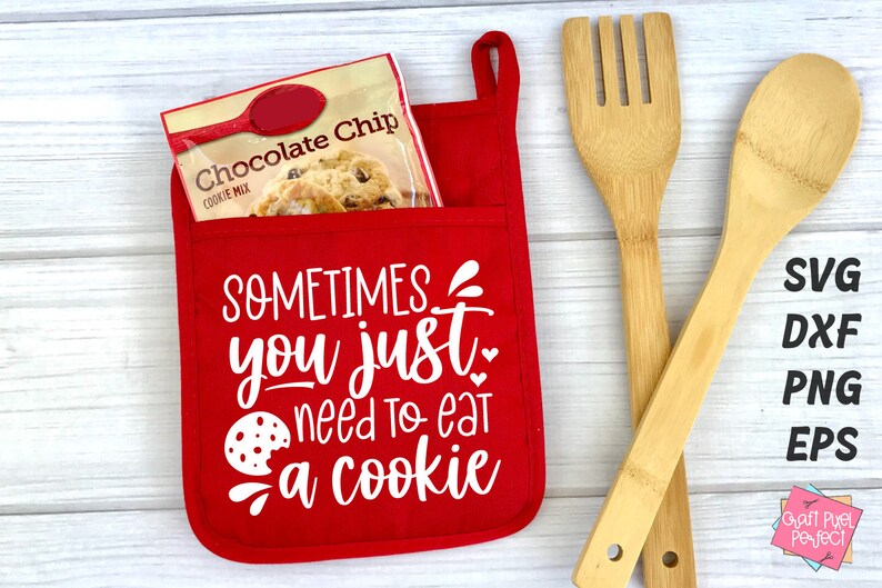 May include: Red oven mitt with a pocket that holds a bag of chocolate chip cookie mix. The oven mitt has the text "SOMETIMES you just need to eat a cookie" printed on it.