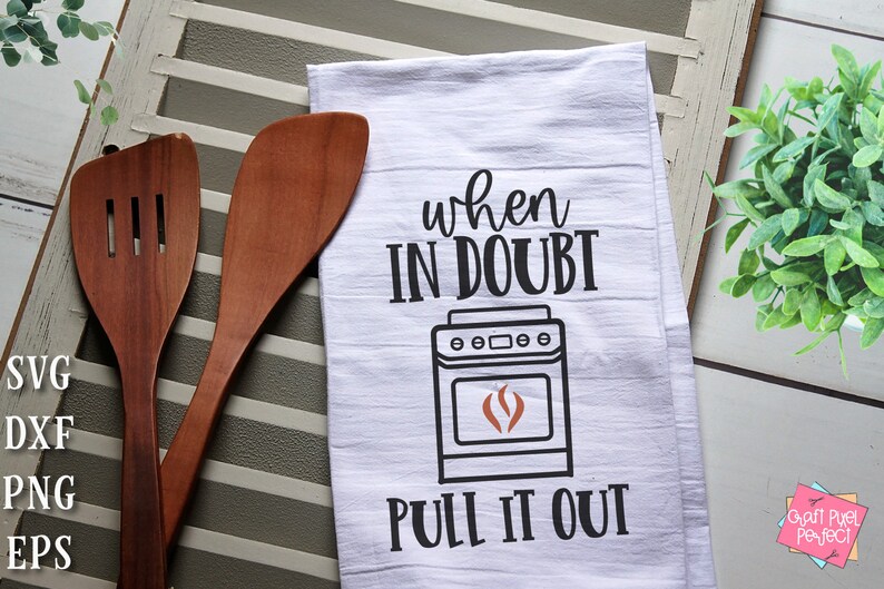 May include: White kitchen towel with black text that reads "When in doubt, pull it out."  A black and white illustration of a stove with a red flame is above the text.