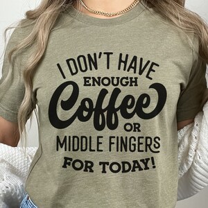 May include: A green t-shirt with the text "I don't have enough coffee or middle fingers for today!" printed in black.