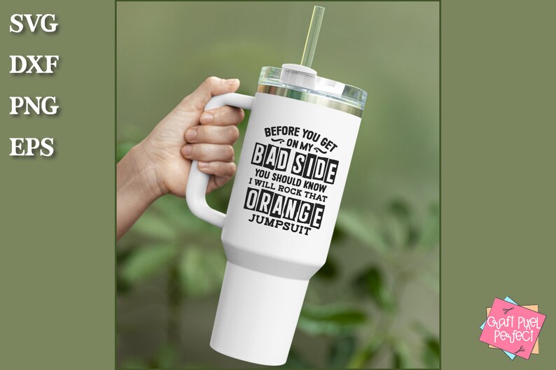 May include: White travel mug with a black handle and a black graphic that reads "Before you get on my bad side you should know I will rock that orange jumpsuit".