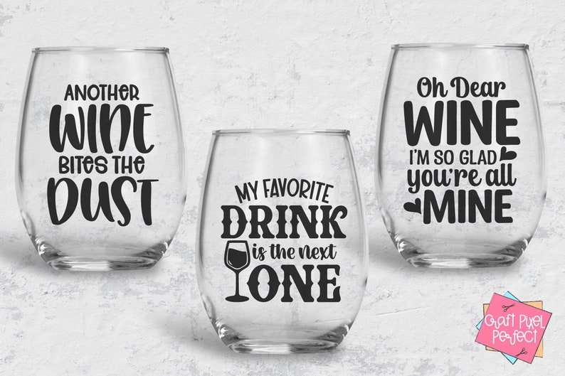 May include: Three wine glasses with funny sayings printed on them. The first glass says "Another Wine Bites the Dust". The second glass says "My Favorite Drink is the Next One". The third glass says "Oh Dear Wine I'm So Glad You're All Mine".
