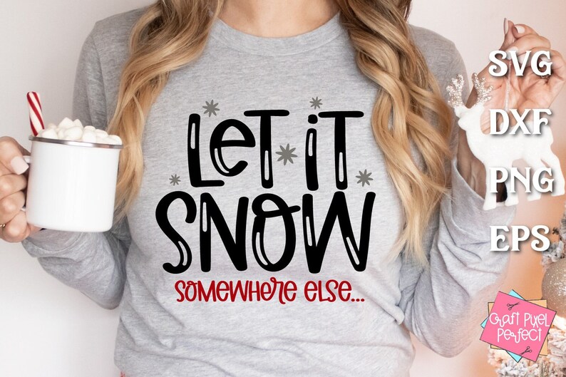 May include: A gray sweatshirt with the text "Let it snow somewhere else..." in black and red lettering. The text is surrounded by small white stars.
