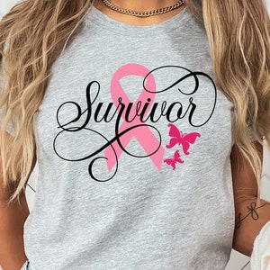 May include: A gray t-shirt with the word "Survivor" written in black cursive script. A pink ribbon is behind the word and two pink butterflies are above the word.