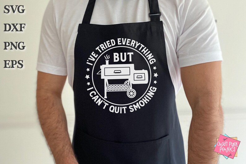 May include: Black apron with a white circle design featuring a grill and the text "I've tried everything but I can't quit smoking".