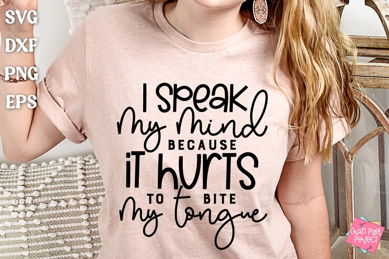 May include: A pink t-shirt with black text that reads "I speak my mind because it hurts to bite my tongue".