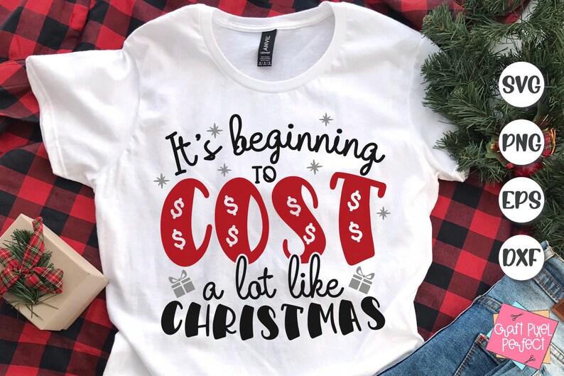 May include: White t-shirt with the text "It's beginning to cost a lot like Christmas" in black and red lettering. The word "cost" is surrounded by dollar signs.