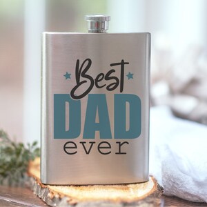 May include: A silver flask with a blue and black design that says "Best Dad Ever".