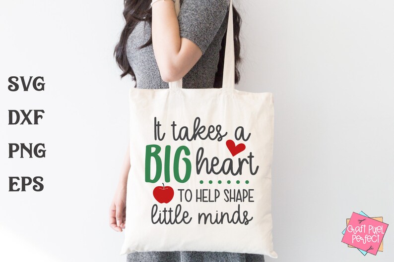 May include: A white tote bag with the text "It takes a BIG heart ... TO HELP SHAPE little minds" in green and black lettering. A red heart and a red apple are also included in the design.