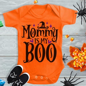 May include: Orange baby onesie with black text that reads "Mommy is my Boo" with a witch hat and stars above the text.