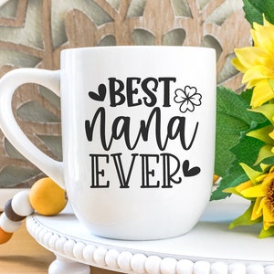 May include: White ceramic mug with a black design that says "BEST nana EVER" with a heart and a four-leaf clover.