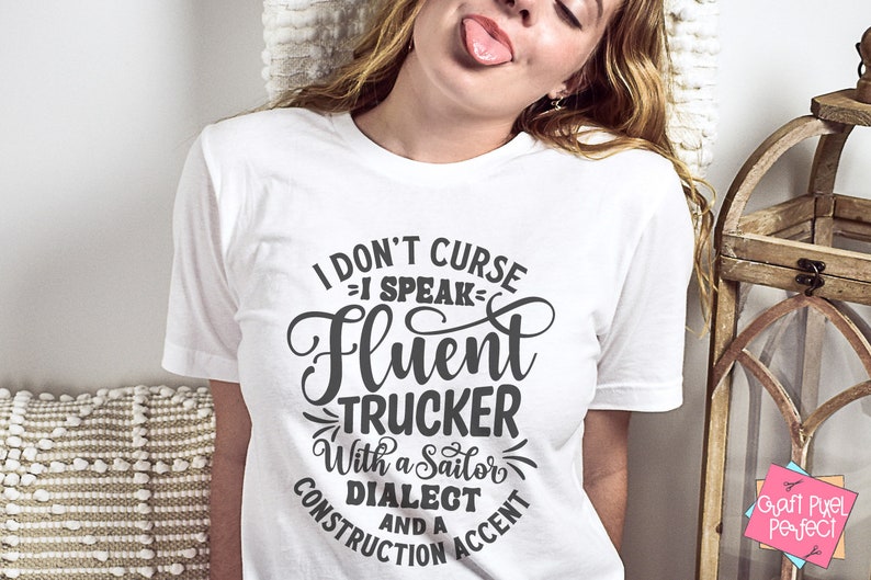 May include: White t-shirt with a black graphic that reads "I don't curse - I speak fluent trucker with a sailor dialect and a construction accent".