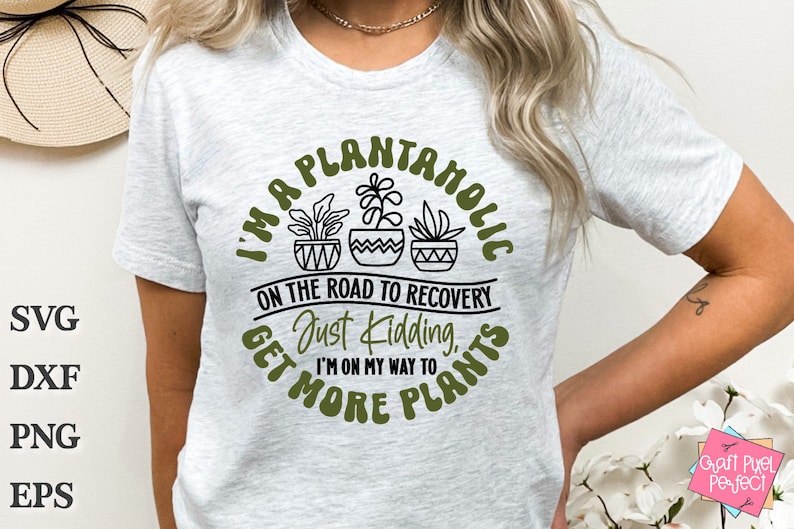 May include: A white t-shirt with a green circle graphic that says "I'm a Plantaholic on the road to recovery. Just kidding, I'm on my way to get more plants."