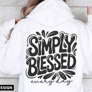 May include: White hoodie with the phrase "SIMPLY BLESSED every day" in a black, stylized font on the back. The design includes decorative flourishes. The image also includes the text "SVG DXF PNG EPS" and "DIGITAL DESIGN".