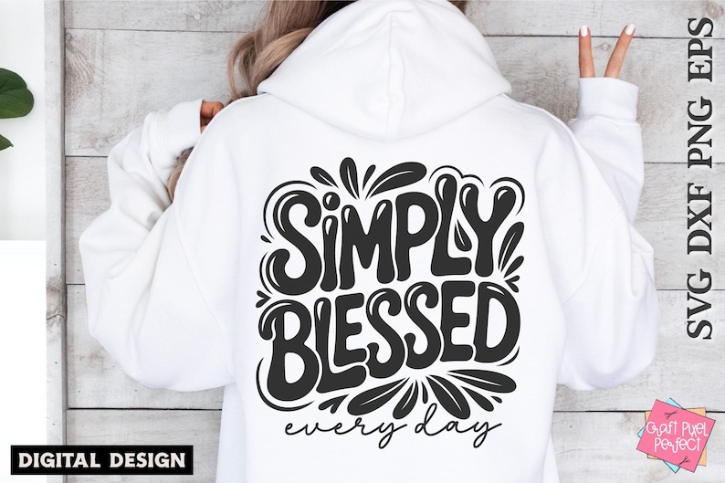 May include: White hoodie with the phrase "SIMPLY BLESSED every day" in a black, stylized font on the back. The design includes decorative flourishes. The image also includes the text "SVG DXF PNG EPS" and "DIGITAL DESIGN".