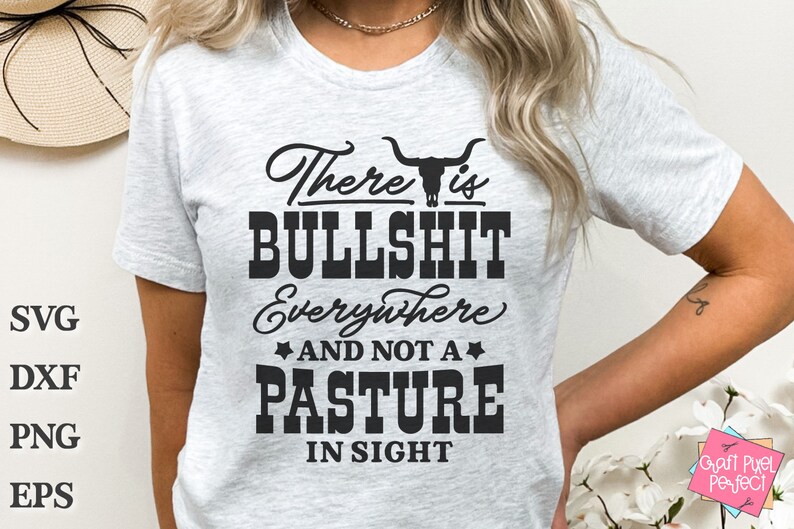 May include: A white t-shirt featuring a black graphic that reads "There is BULLSHIT Everywhere AND NOT A PASTURE IN SIGHT". The graphic also includes a stylised bull skull.