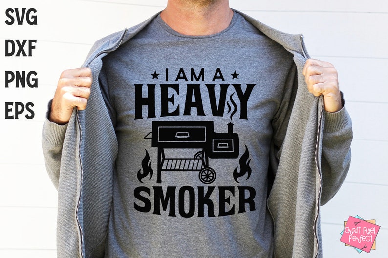 May include: A gray t-shirt with black text that reads "I am a Heavy Smoker" with a black silhouette of a smoker grill and flames below the text.