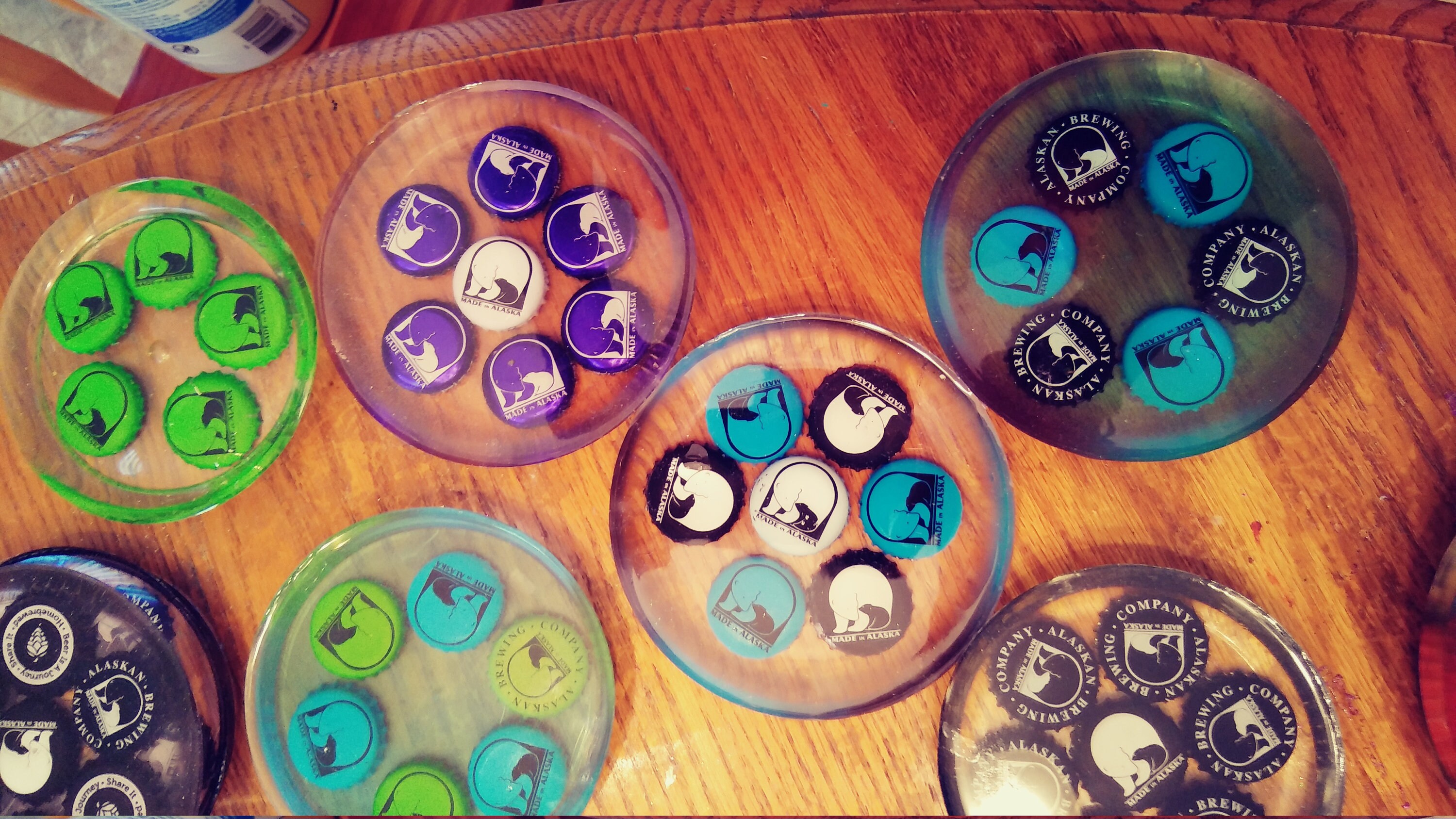 Made in Alaska brewery bottle caps in epoxy coasters. 67 caps Etsy