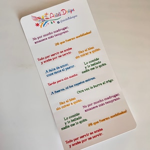 May include: A set of colorful stickers with Spanish sayings. The stickers feature a variety of colors and fonts. The text on the stickers includes phrases like "No por mucho madrugar, amanece más temprano" and "Todo por servir se acaba y acaba por no servir".