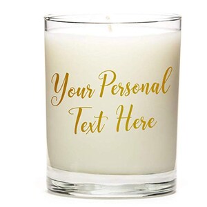 May include: A clear glass candle jar with a white candle inside. The candle has gold lettering that says "Your Personal Text Here".