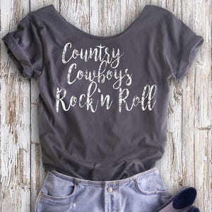 Buy 2, Get 1 FREE Tshirt Country Cowboys Rock &#39;n Roll Women&#39;s Off  Shoulder Slouchy Tee. Choice of 4 Colors!
