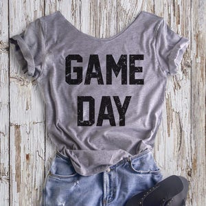 Buy 2, Get 1 FREE Tshirt GAME DAY Women&#39;s Off  Shoulder Slouchy Tee. Choice of 4 Colors!