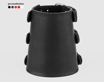 May include: Black leather wrist cuff with multiple adjustable straps and a buckle closure.